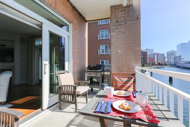 balcony with a grill and a water view