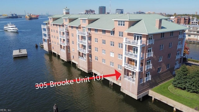 view of building exterior with a water view and central AC