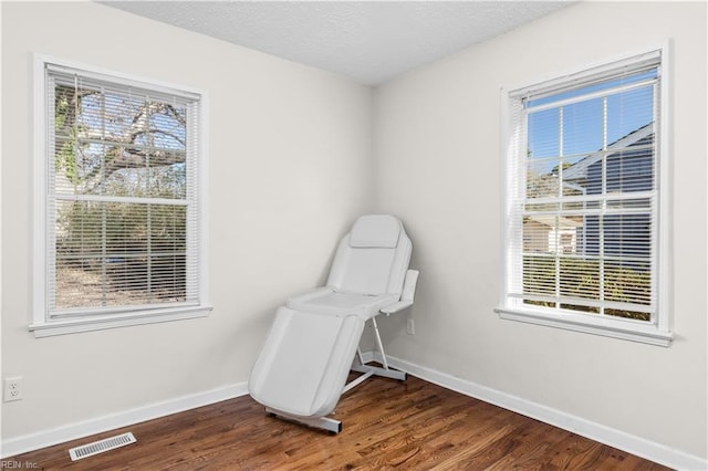 unfurnished room featuring dark hardwood / wood-style floors and a textured ceiling