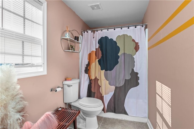 bathroom featuring tile patterned flooring and toilet