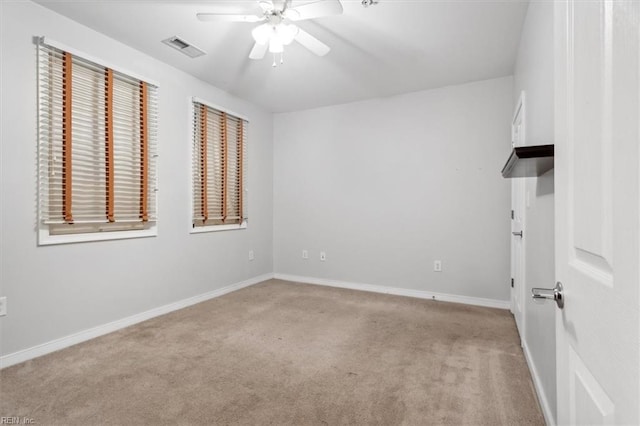 spare room featuring ceiling fan and light carpet