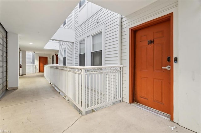 view of exterior entry featuring covered porch