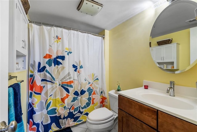 bathroom featuring toilet, tile patterned flooring, and vanity