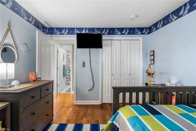 bedroom featuring hardwood / wood-style floors and a closet