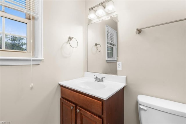 bathroom featuring toilet and vanity