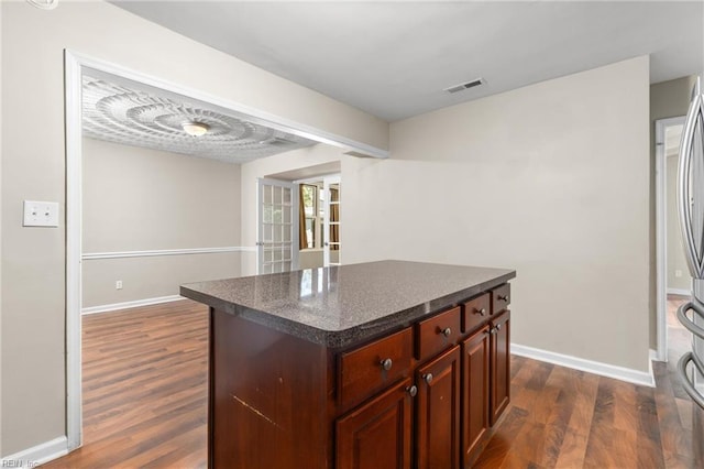 kitchen featuring a kitchen island, french doors, and dark hardwood / wood-style floors