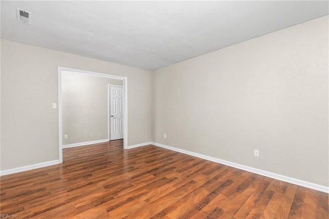 spare room with dark wood-type flooring