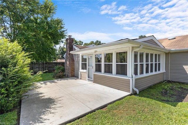 view of home's exterior with a patio area and a yard