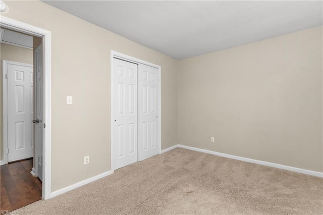 unfurnished bedroom with carpet and a closet