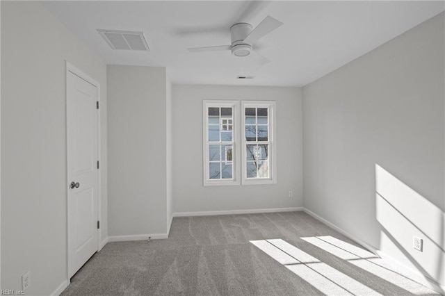 carpeted spare room featuring ceiling fan