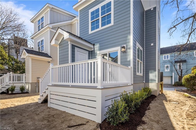 rear view of house featuring a wooden deck