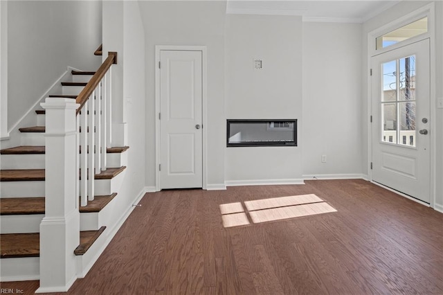 entrance foyer featuring crown molding and dark hardwood / wood-style floors