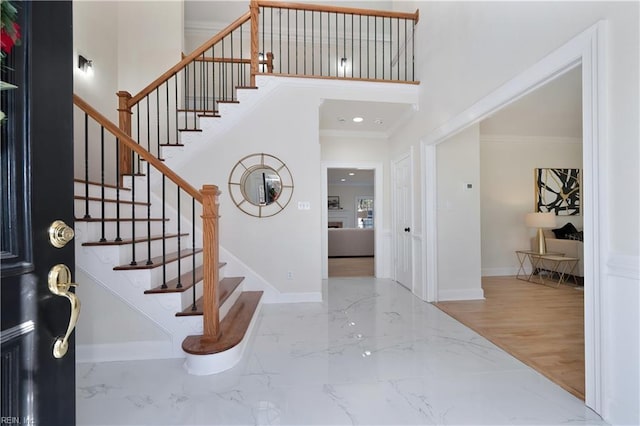 entrance foyer featuring hardwood / wood-style floors and crown molding