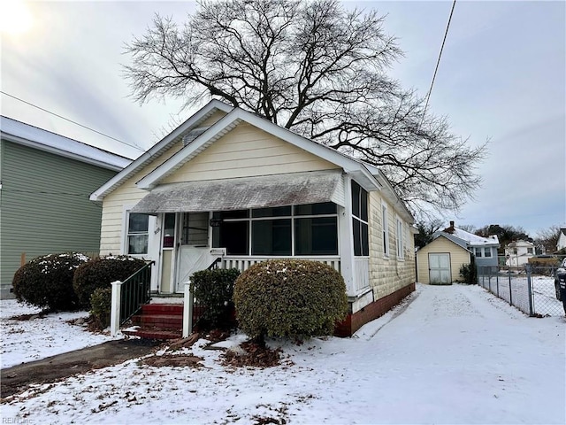 bungalow-style house featuring a shed