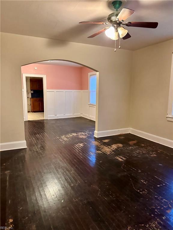 spare room featuring ceiling fan and dark hardwood / wood-style flooring