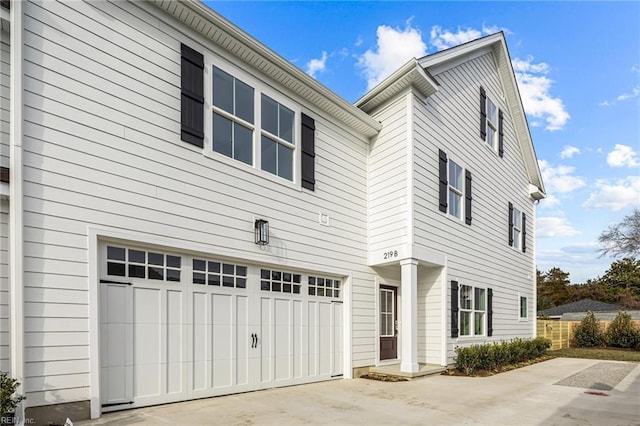 view of home's exterior featuring a garage and driveway