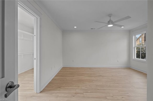 empty room with baseboards, ceiling fan, crown molding, light wood-style floors, and recessed lighting