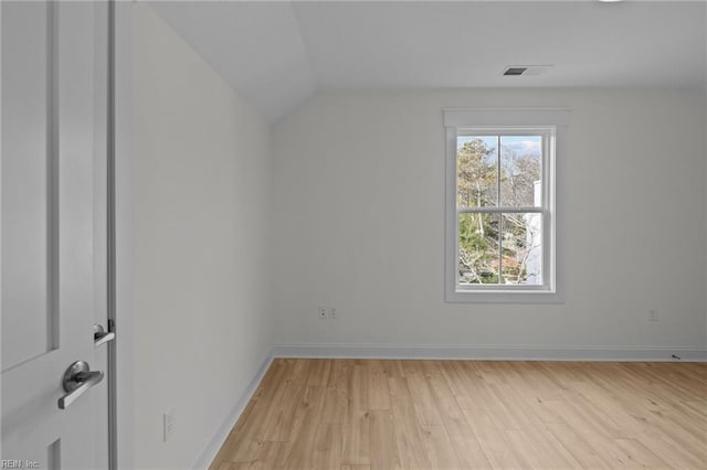 bonus room featuring light wood-style floors, lofted ceiling, visible vents, and baseboards