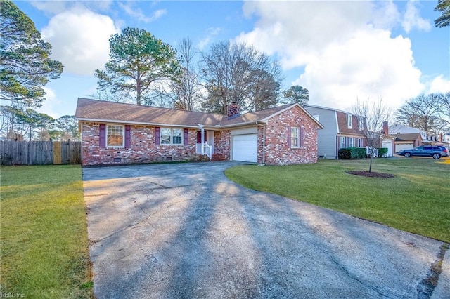 single story home featuring a garage and a front lawn