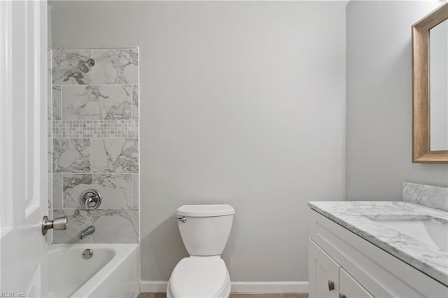 full bathroom featuring tiled shower / bath combo, toilet, and vanity