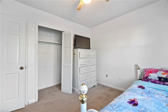 carpeted bedroom with a closet and ceiling fan