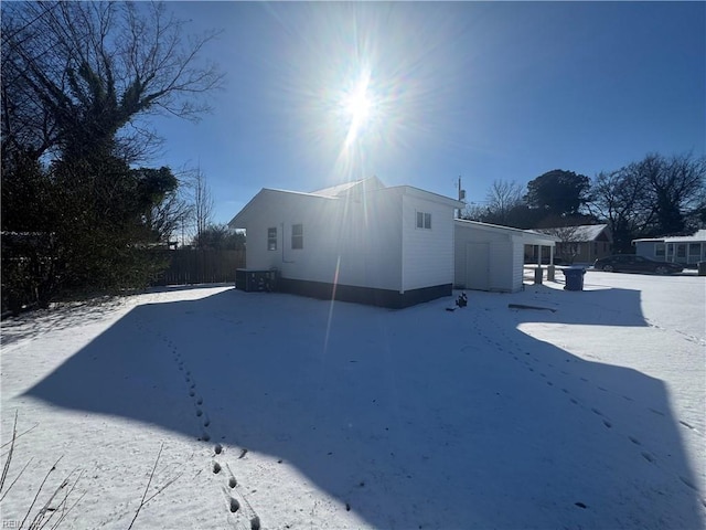 view of snow covered exterior featuring cooling unit