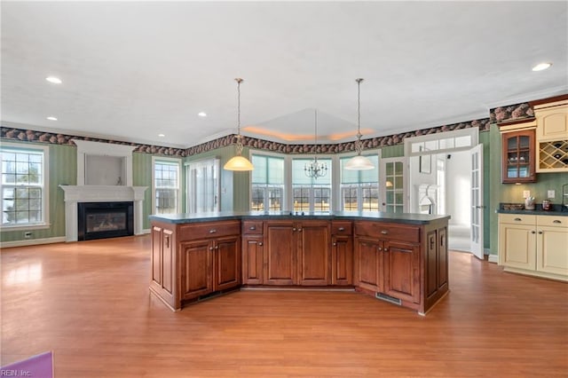 kitchen featuring a center island, hanging light fixtures, and plenty of natural light