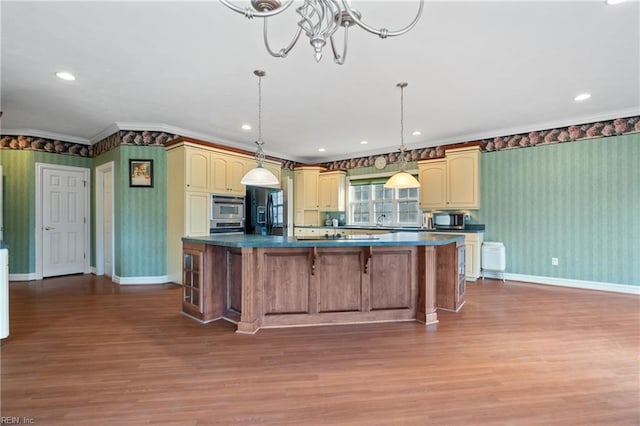 kitchen featuring hardwood / wood-style flooring, sink, ornamental molding, and black fridge with ice dispenser