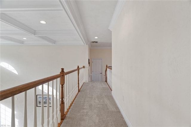 hallway featuring light carpet, ornamental molding, beamed ceiling, and coffered ceiling