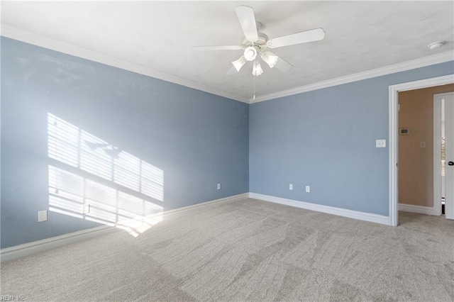 carpeted empty room with ceiling fan and ornamental molding