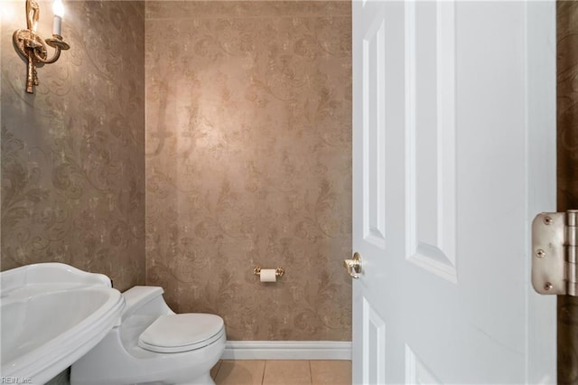 bathroom with sink, tile patterned floors, and toilet