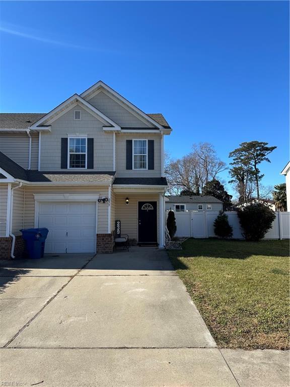 view of front property featuring a garage and a front lawn