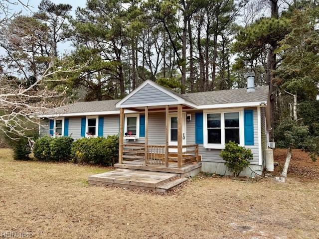 view of front of house with a porch and a front yard