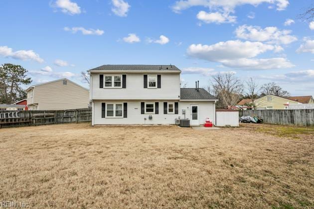 back of property featuring cooling unit and a lawn