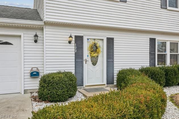 view of exterior entry featuring a garage