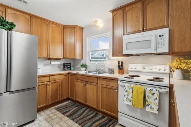 kitchen featuring sink and white appliances