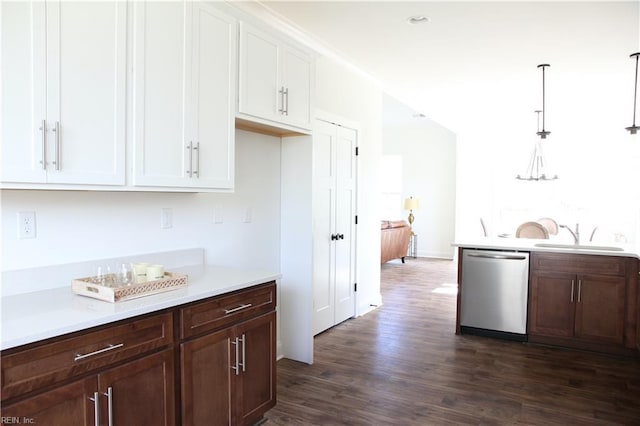 kitchen with sink, dark wood-type flooring, dishwasher, white cabinets, and decorative light fixtures