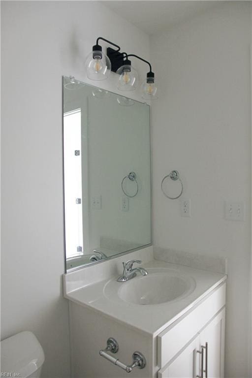 bathroom with vanity and toilet