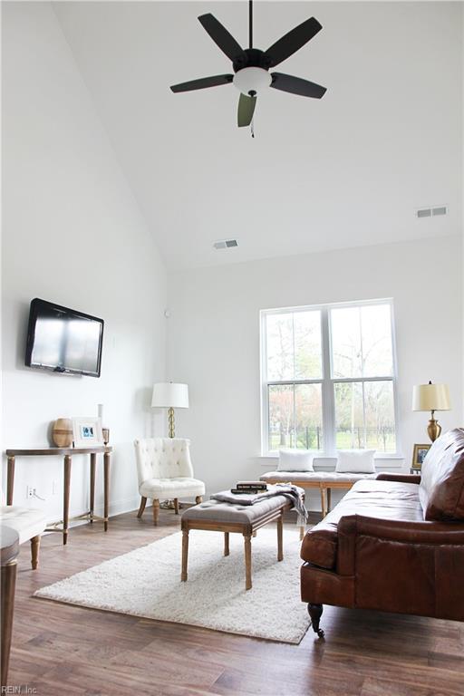 living room with ceiling fan, high vaulted ceiling, and hardwood / wood-style floors