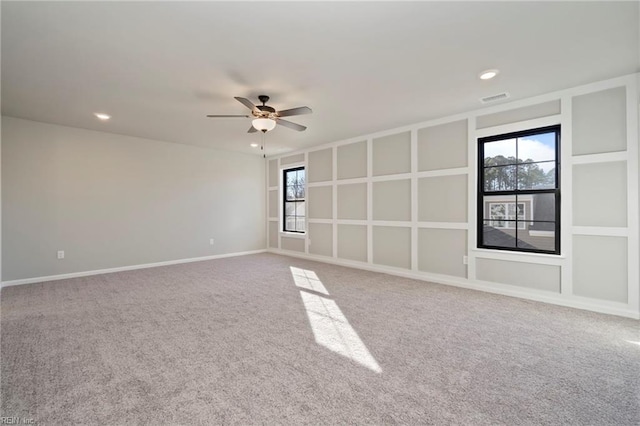 empty room with ceiling fan and carpet flooring