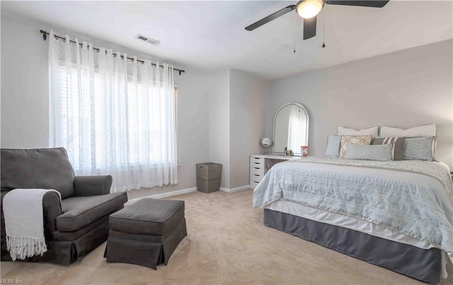 carpeted bedroom with multiple windows and ceiling fan