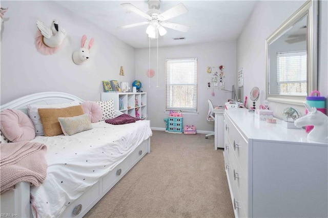 carpeted bedroom featuring ceiling fan and multiple windows