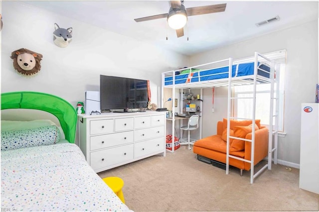 carpeted bedroom featuring ceiling fan and white fridge