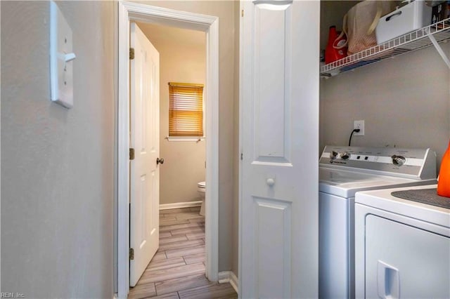 clothes washing area with washer and clothes dryer