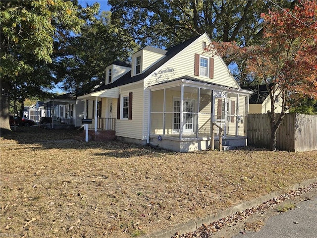 view of front facade with a sunroom and a porch