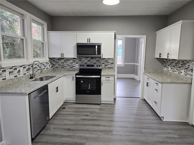 kitchen with sink, white cabinets, and stainless steel appliances