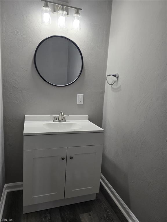 bathroom with vanity and wood-type flooring