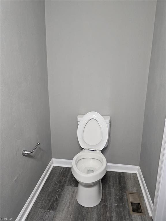 bathroom featuring hardwood / wood-style floors and toilet