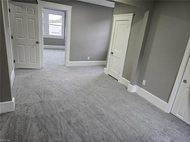 spare room featuring light carpet