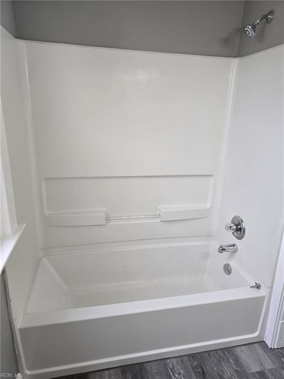 bathroom with  shower combination and wood-type flooring